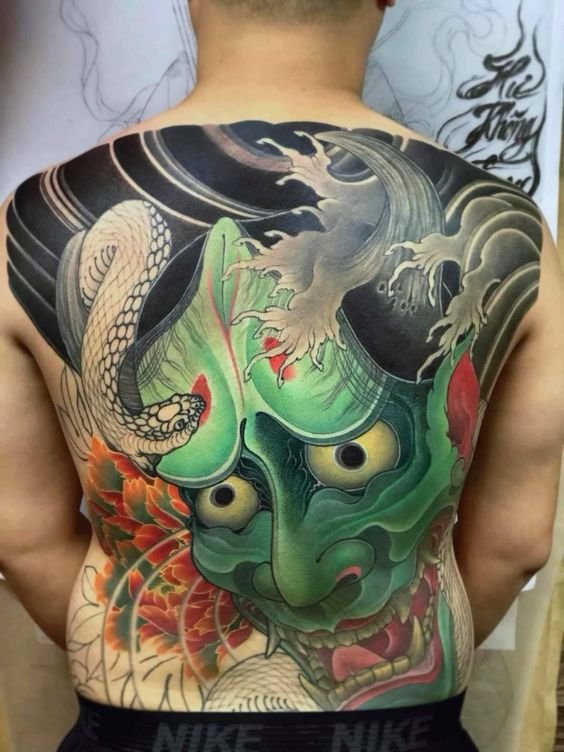 Tatoo mặt quỷ xanh lá đi kèm một chiếc rắn trắng